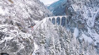 Landwasser Viaduct with Glacier and Bernina express in switzerland snow