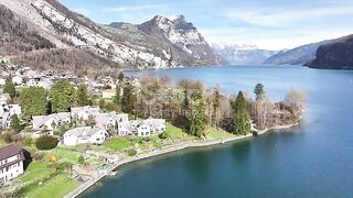 An aerial of the shoreline of Weesen in , Switzerland, along Lake Walensee, Swiss-style residential areas bordering the tranquil lake waters