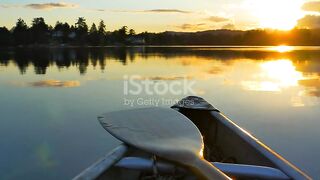 Old boat calm water and kayaker at sunset, golden hour sea rustic boat