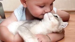 Cute baby playing with cute cat