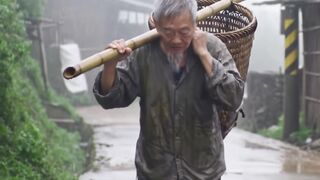 The old man is climbing in mountain rainy time.!