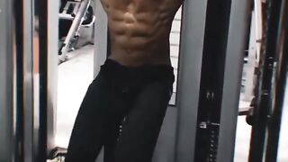 A young boy is doing a challenging workout at the gym.
