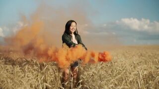 Happy girl Jumping with a Smoke flare