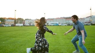 A cute couple playing on the grass