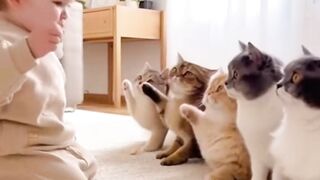 Adorable Baby Sitting with Four Curious Cats in a Bright Cozy Room