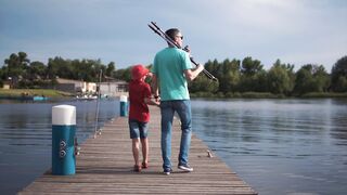 Father and son walk the deck looking for a fishing spot