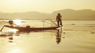 Traditional fishermen on boats at sunset