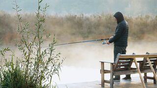 Someone is fishing in the lake near me