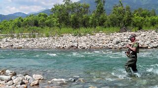 A person is fishing in the river