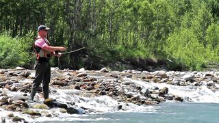 A person is fishing in the river