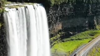 The Beauty of Nature  Waterfall Amid Lush Green Rice Fields
