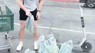 Man brings picks up groceries on a scooter