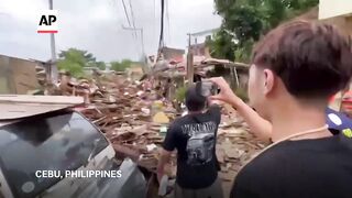 Typhoon leaves at least 2 dead, traps people on roofs and submerges cars in central