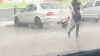 A parking lot during a heavy downpour .
