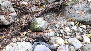 Girl Exploring a Rocky Creek in Autumn Nature