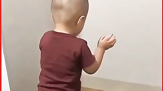 The cute baby is learning to pray