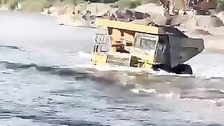 Sand loaded truck crossing the river dumptruck