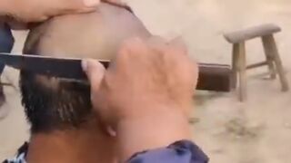 very funny a barber haircutting his customer with big knife