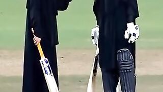 Burka women playing cricket.