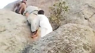A scene of friends climbing high cliffs in Mansehra district