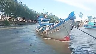 A damaged fishing boat in the middle of the ocean