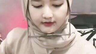 woman wearing hijab plays guitar with extraordinary skill