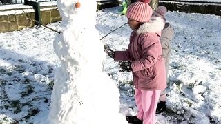 Rolling white balls and stacking them