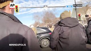 Federal agents use tear gas as crowd confronts them in Minneapolis.