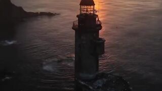 Aniva Lighthouse in the dawn rays of the sun