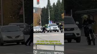 Police motorcycle chase. One of the racers does a real stunt
