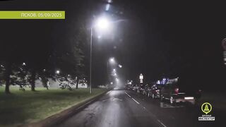 Night traffic police car chase during rain
