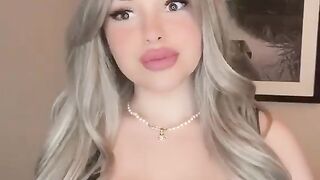 She flaunts her large breasts.