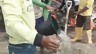 People Mixing Concrete for Construction Work – Outdoor Building Activity