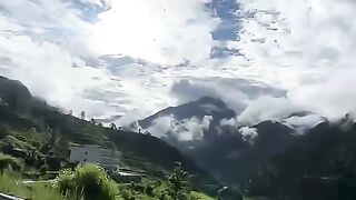 Neil stood on a mountain peak,