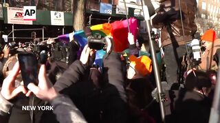 New York officials raise a rainbow flag at Stonewall National Monument.