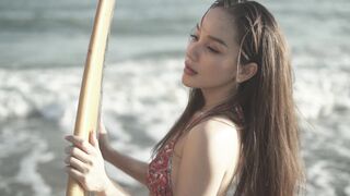 Woman Within - a woman projecting in front of a camera while holding a surfboard | Trending HD