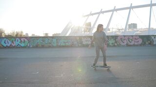 Woman Within - young woman skateboarding at urban bridge sunrise | Trending HD Video