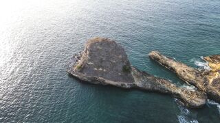 NatureWise - brown rock formation on the blue sea | Trending HD Video