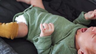 Babymoov - a mother putting socks on her baby | Trending HD Video