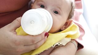 BaByliss - mother feeding her son on her lap | Trending HD Video