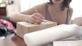 BaByliss - women writing on parcel boxes | Trending HD Video