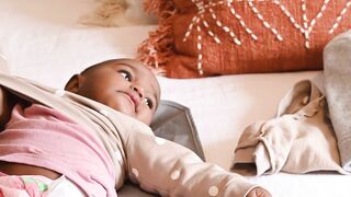 BaByliss - person changing clothes of a baby | Trending HD Video