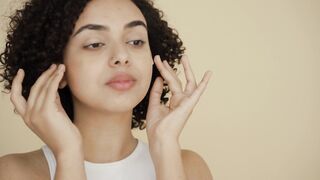 Funnyfuzzy - a woman applying face path under her eyes | Trending HD Video