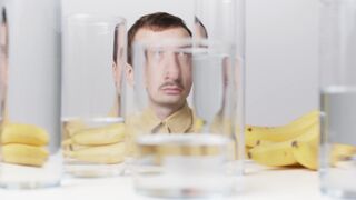 Notes on Being a Man - a man looking at camera with drinking glasses in front of him | Trending
