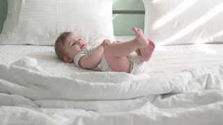 BabyBj rn - baby lying down on bed | Trending HD Video