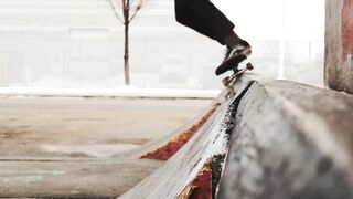 Action figure - slow motion footage of a skateboarder doing tricks on the street side under a b