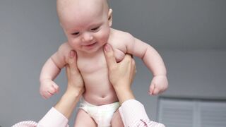 Baby Toys - a person holding a baby wearing diaper | Trending HD Video