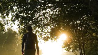 Action figure - a man walking down a path with the sun shining behind him | Trending HD Video