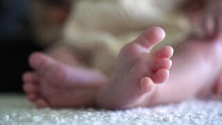 Baby Toys - close up of adorable baby feet on soft fabric | Trending HD Video