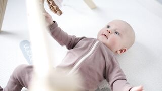 BabyBj rn - a baby holding his hanging toy | Trending HD Video